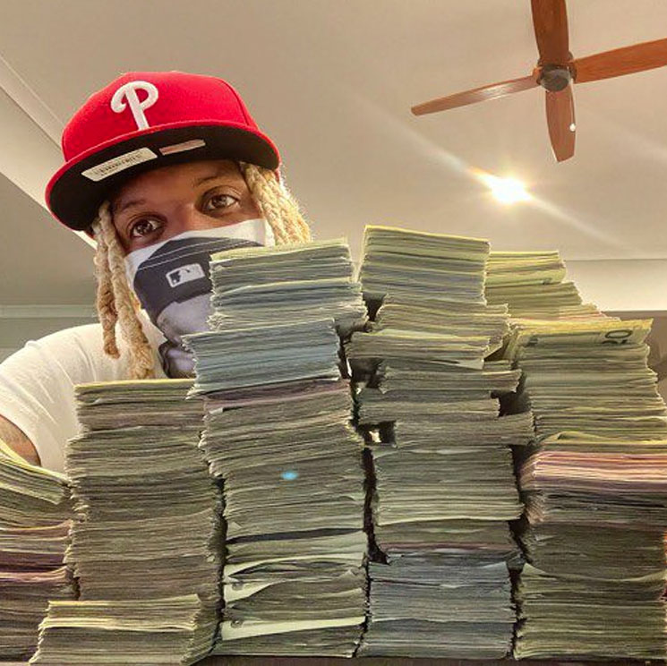 Photo of Lil Durk posing with stacks of cash money