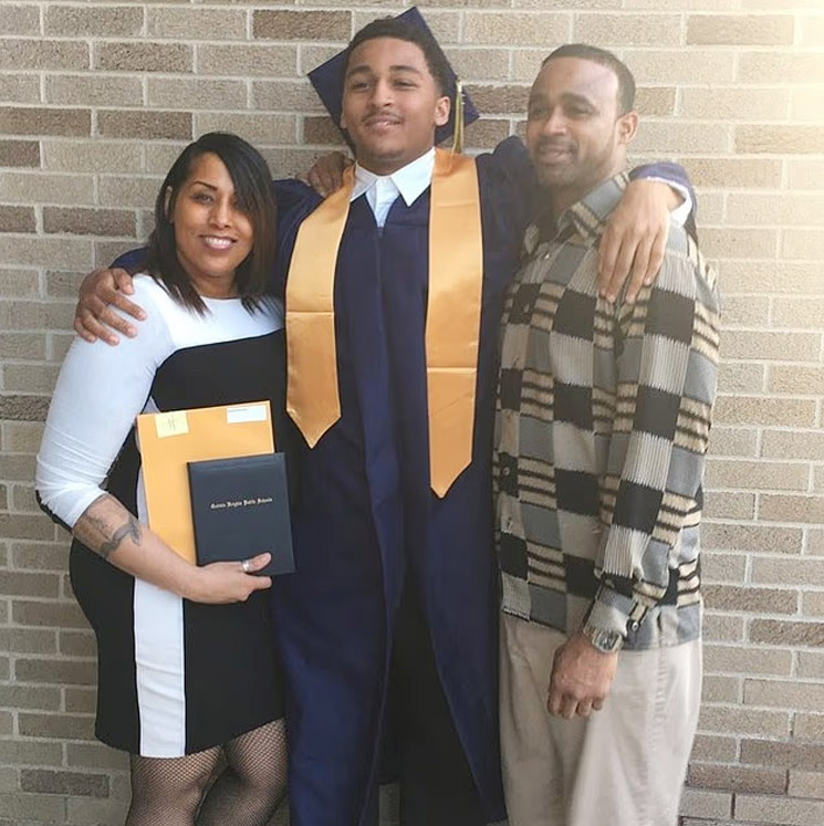 Photo of Marshawn Kneeland and his parents at his graduation
