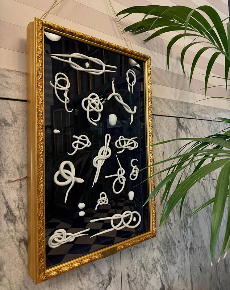 Photo of framed art on a wall