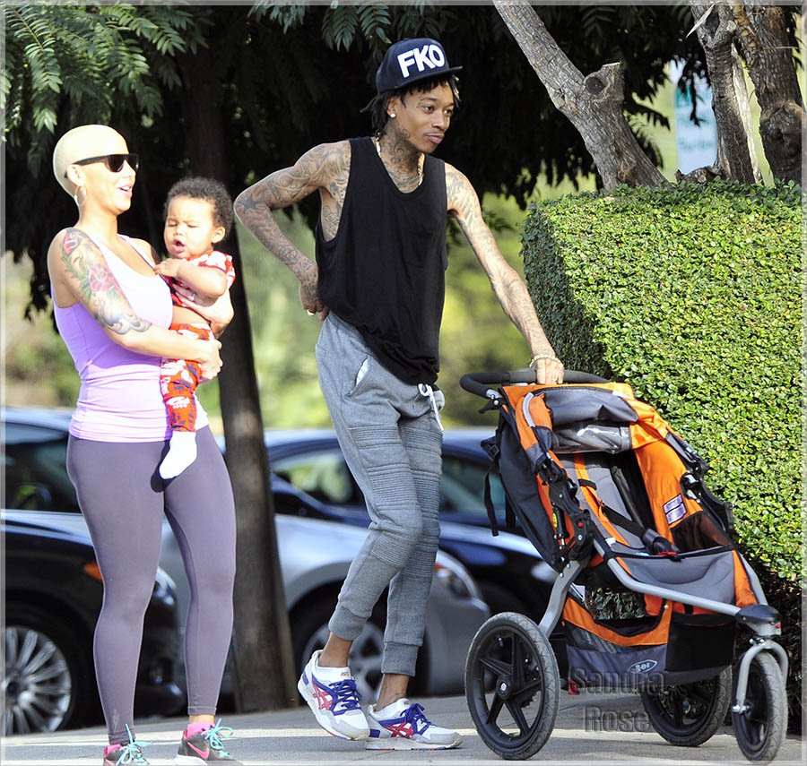 Pot head rapper Wiz Khalifa, 26, was seen on a stroll with his wife Amber R...