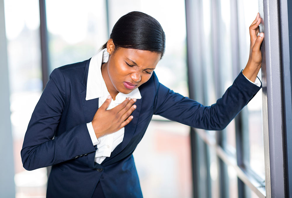 young African American businesswoman having heart attack