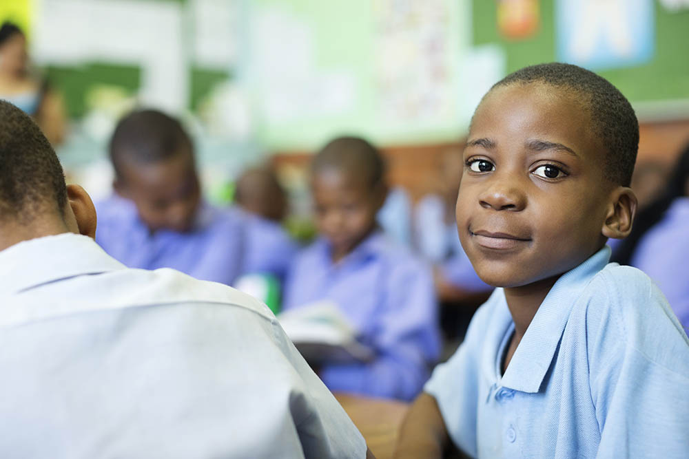 Schoolboy smiling in class