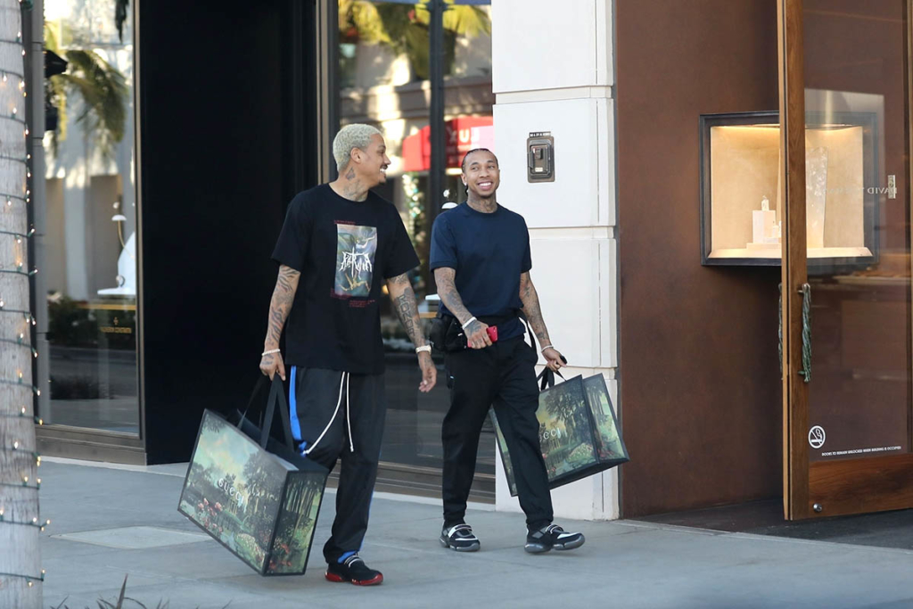 Tyga shops at Gucci with his partner