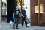 Tyga shops at Gucci with his partner