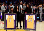 Kobe Bryant poses with his family at halftime after both his #8 and #24 Los Angeles Lakers jerseys are retired