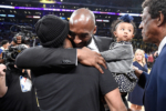 Kobe Bryant hugs Allen Iverson at halftime after both of Bryant's #8 and #24 Los Angeles Lakers jerseys are retired