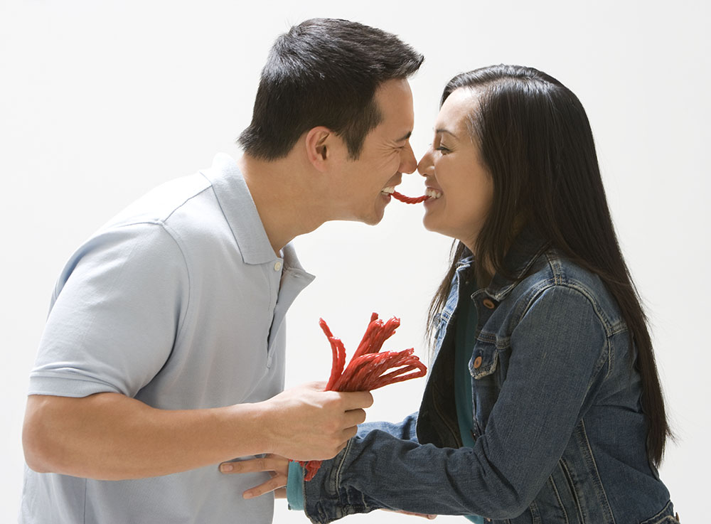 Asian couple eating licorice