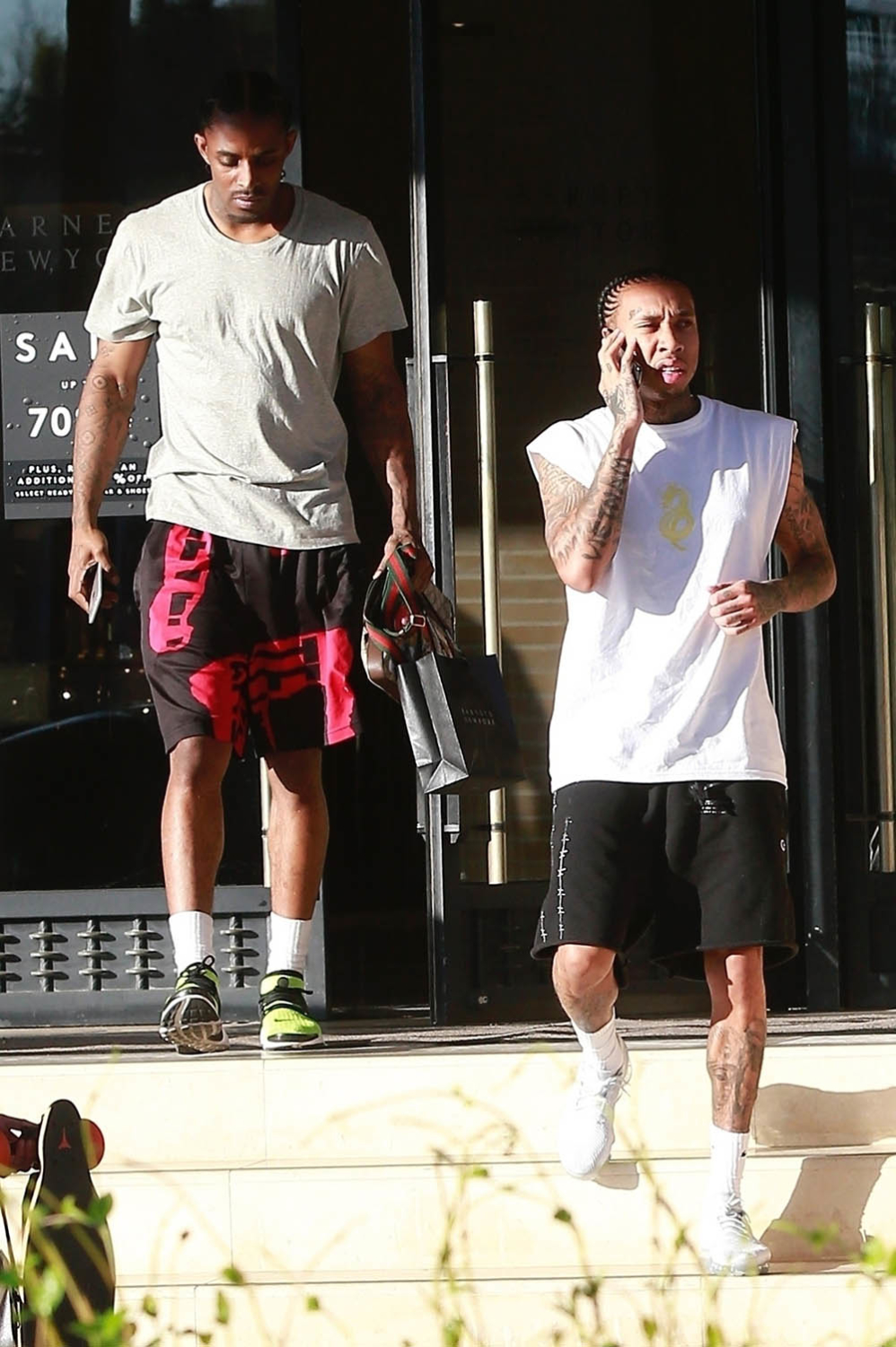 Tyga looked casual as he leaves Barneys New York with a friend