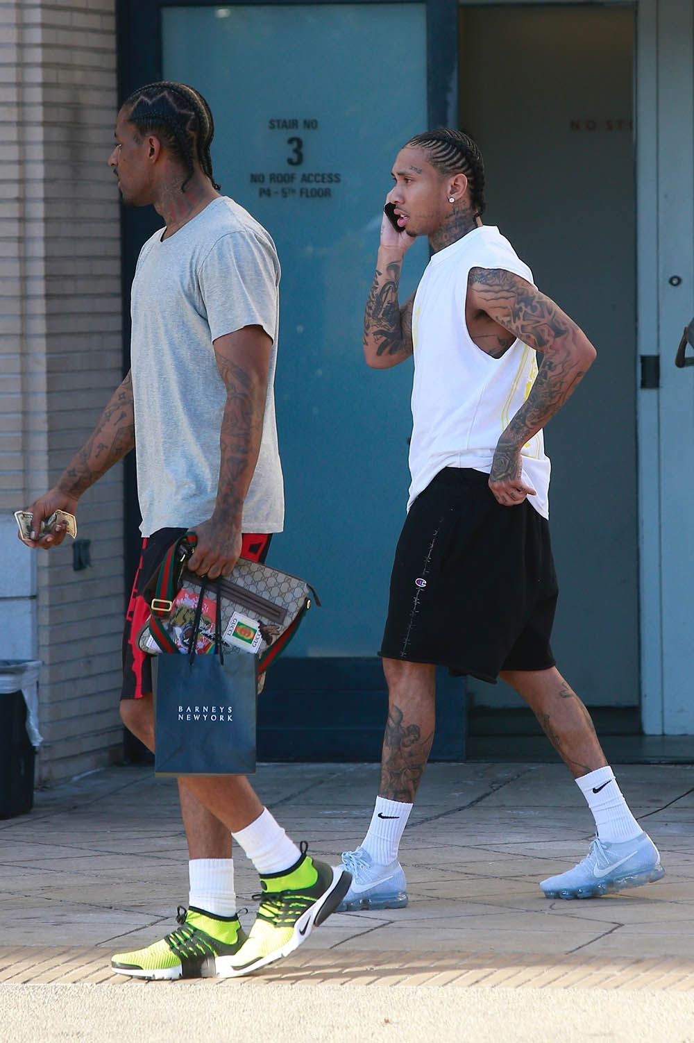 Tyga looked casual as he leaves Barneys New York with a friend