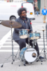 Questlove plays drums on the sidewalk in Tribeca