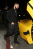 Drake hops into his $7 million Yellow Ferrari