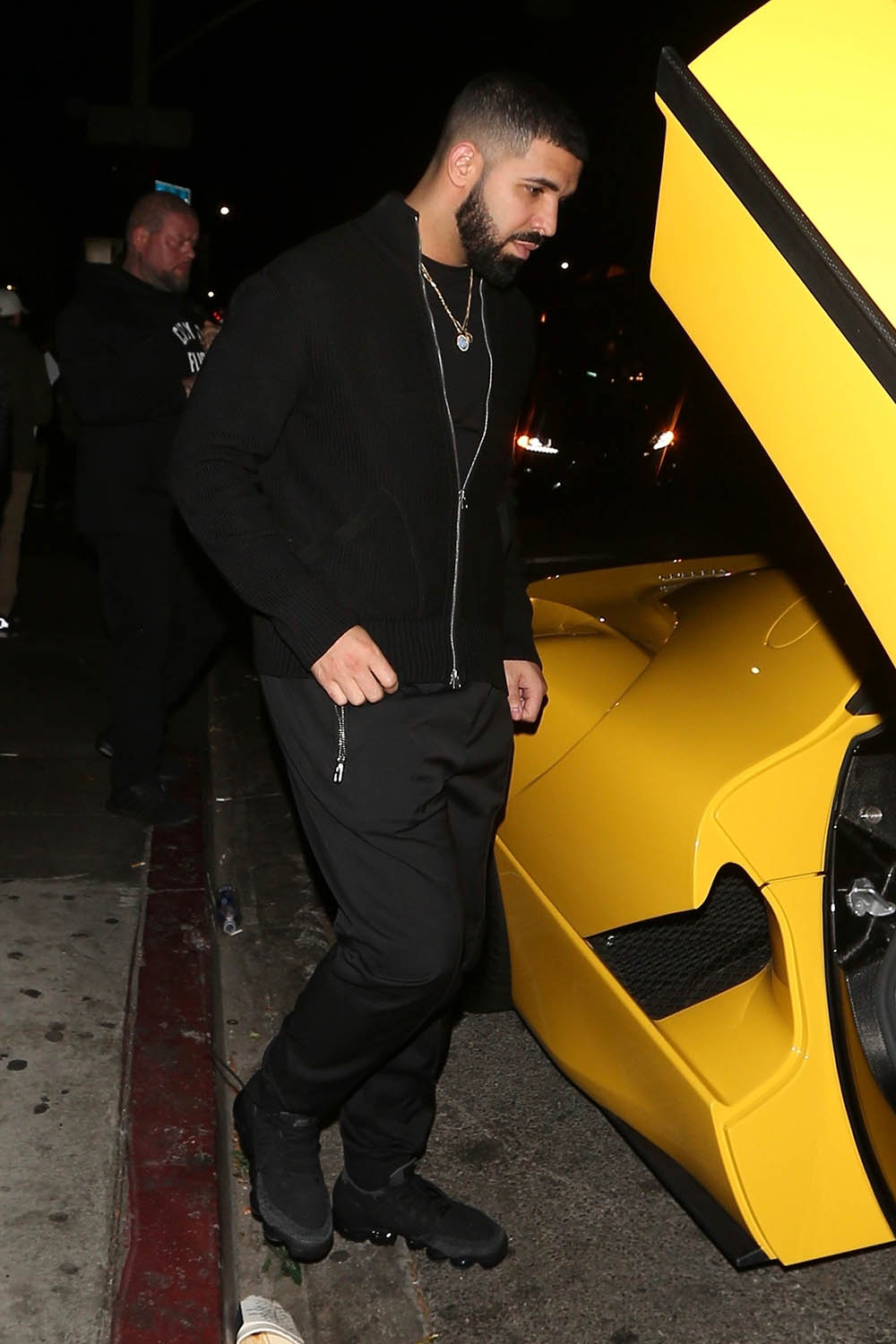 Drake hops into his $7 million Yellow Ferrari