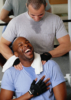 Man in Gym Massaging Shoulders