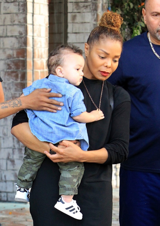New mom Janet Jackson carries her baby boy Eissa in her arms after