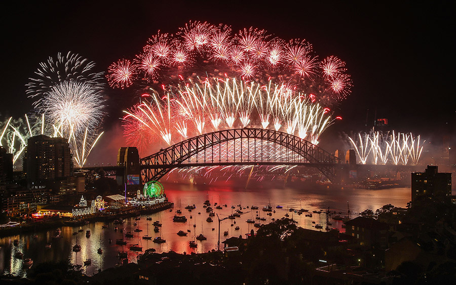 Fireworks explode over the Sydney Harbour Bridge during the midnight