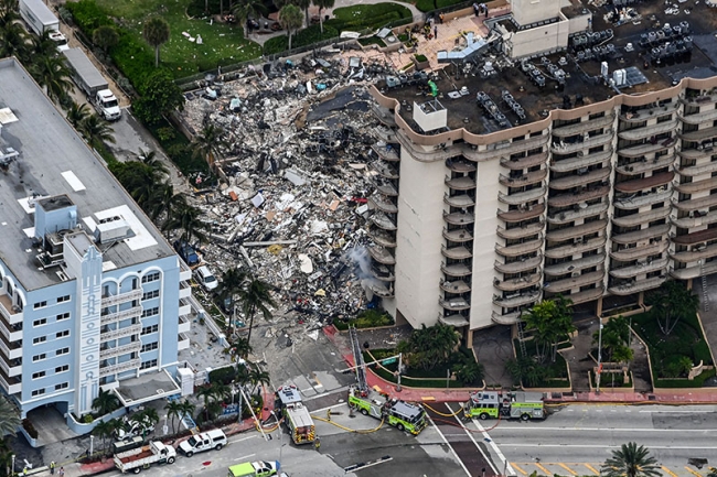 This aerial view, shows search and rescue personnel working on site ...