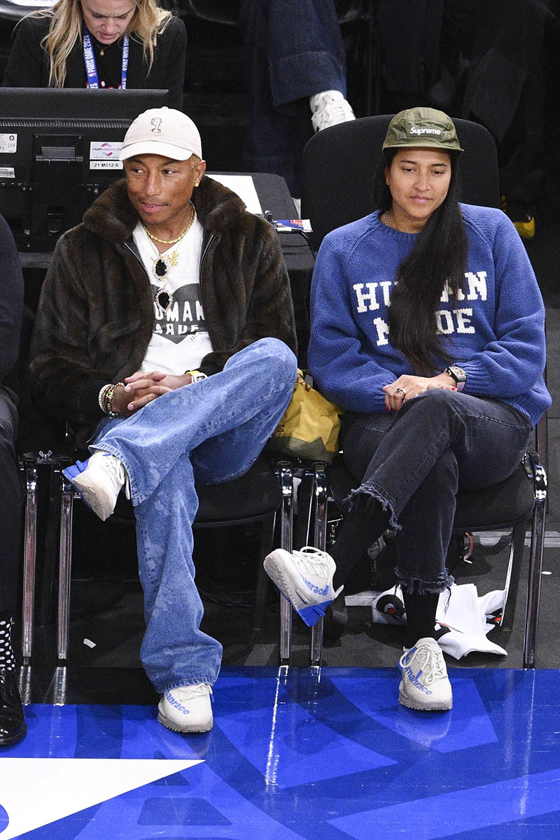 Pharrell Williams and his wife Helen Lasichanh attend the NBA