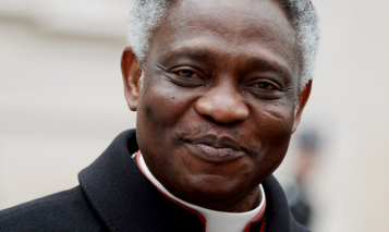 Ghanaian cardinal Peter Kodwo Appiah Turkson arrives to take part in an afternoon meeting of pre-conclave on March 8, 2013 at the Vatican. The day before, the next pope’s ideal profile began to take shape as cardinals held a second day of pre-conclave talks — a man with pastoral experience, missionary energy and few ties to the Vatican’s unruly government.    AFP PHOTO / FILIPPO MONTEFORTE (Photo by Filippo MONTEFORTE / AFP) (Photo by FILIPPO MONTEFORTE/AFP via Getty Images)
