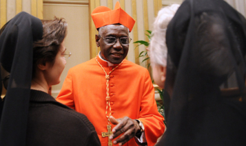 Newly appointed cardinal, Guinean Robert Sarah (C) greets visitors during the traditionnal courtesy visit after the consistory on November 20, 2010 at The Vatican. 24 Roman Catholic prelates joined the Vatican’s College of Cardinals, the elite body that advises the pontiff and elects his successor upon his death.  AFP PHOTO / ALBERTO PIZZOLI (Photo credit should read ALBERTO PIZZOLI/AFP via Getty Images)