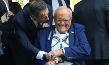 (L/R) Former New York Governor Andrew Cuomo greets former New York City Mayor Rudy Giuliani as they attend the annual 9/11 Commemoration Ceremony at the National 9/11 Memorial and Museum on the 24th anniversary of 9/11 attacks in New York on September 11, 2025. New York on Thursday marked the devastating attacks of September 11, 2001, 24 years after the plane hijackings that claimed almost 3,000 lives and forever changed the United States. (Photo by TIMOTHY A.CLARY / AFP) (Photo by TIMOTHY A.CLARY/AFP via Getty Images)